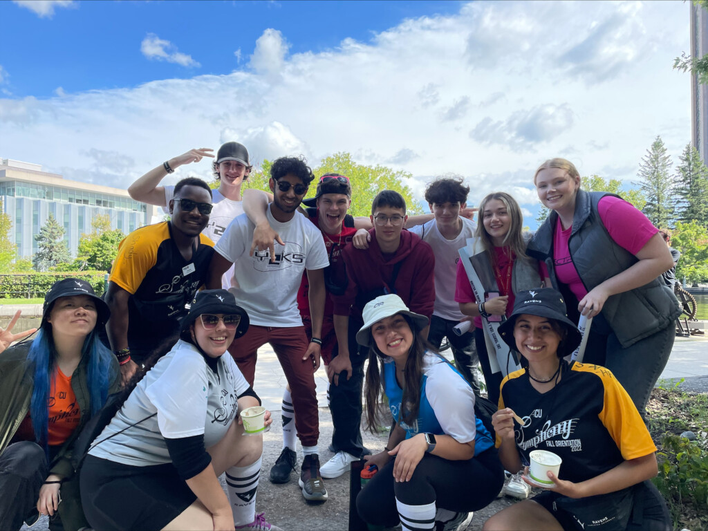 Students posing for group photo outdoors.