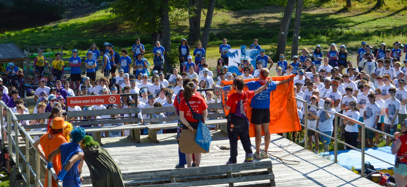 Students on a stage addressing a large crowd.