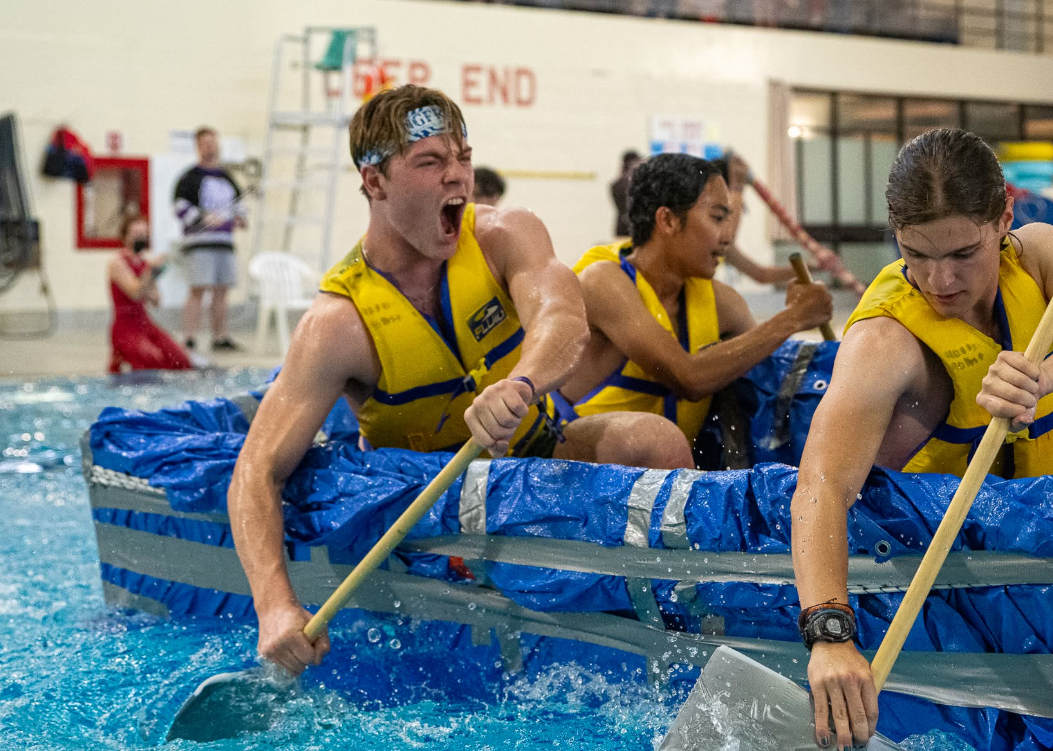Students in a raft while paddling in the pool.