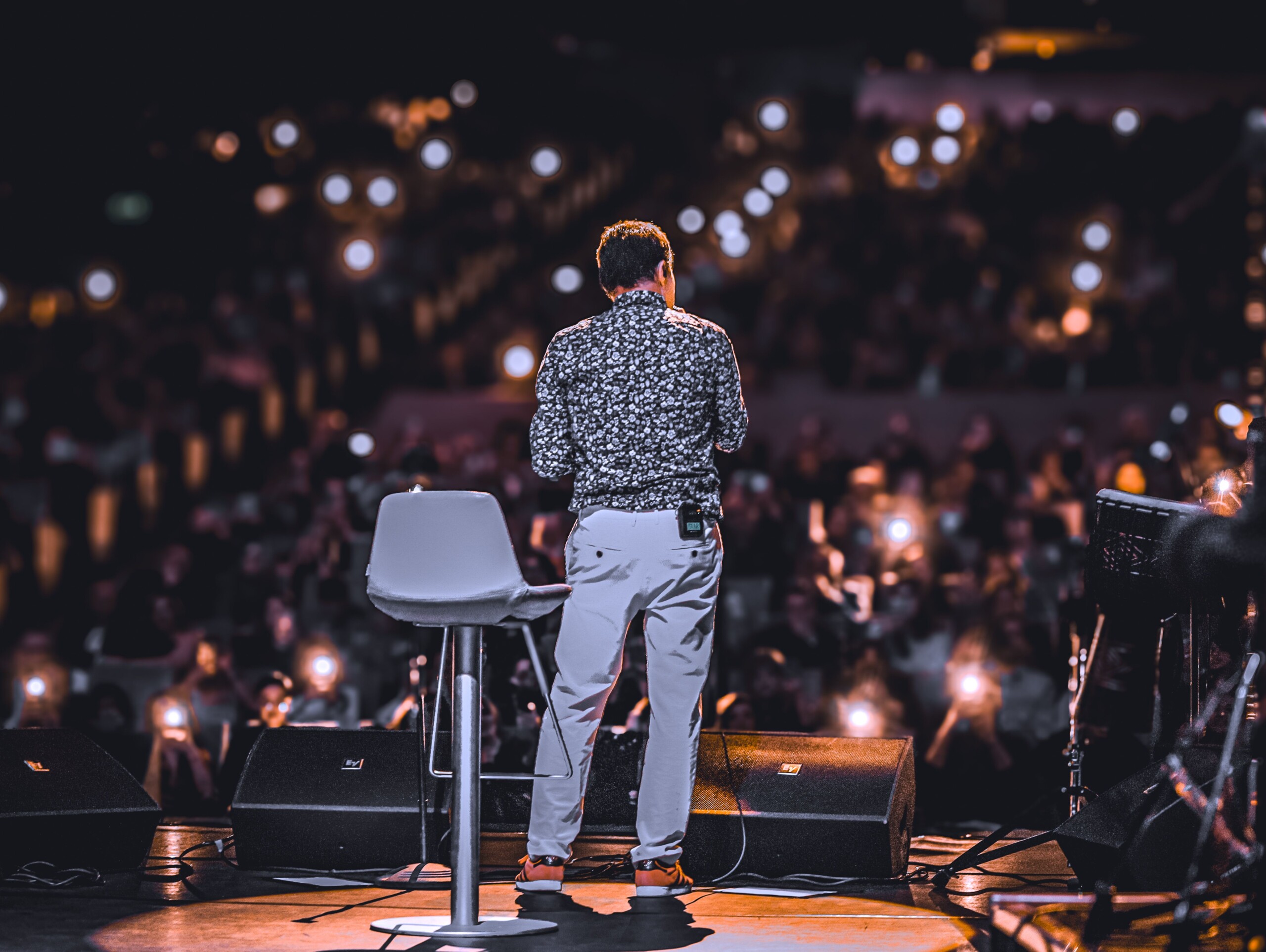 The back image of a comedian on stage.
