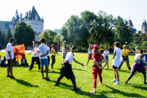 Students playing on the lawn by Parliament Hill.