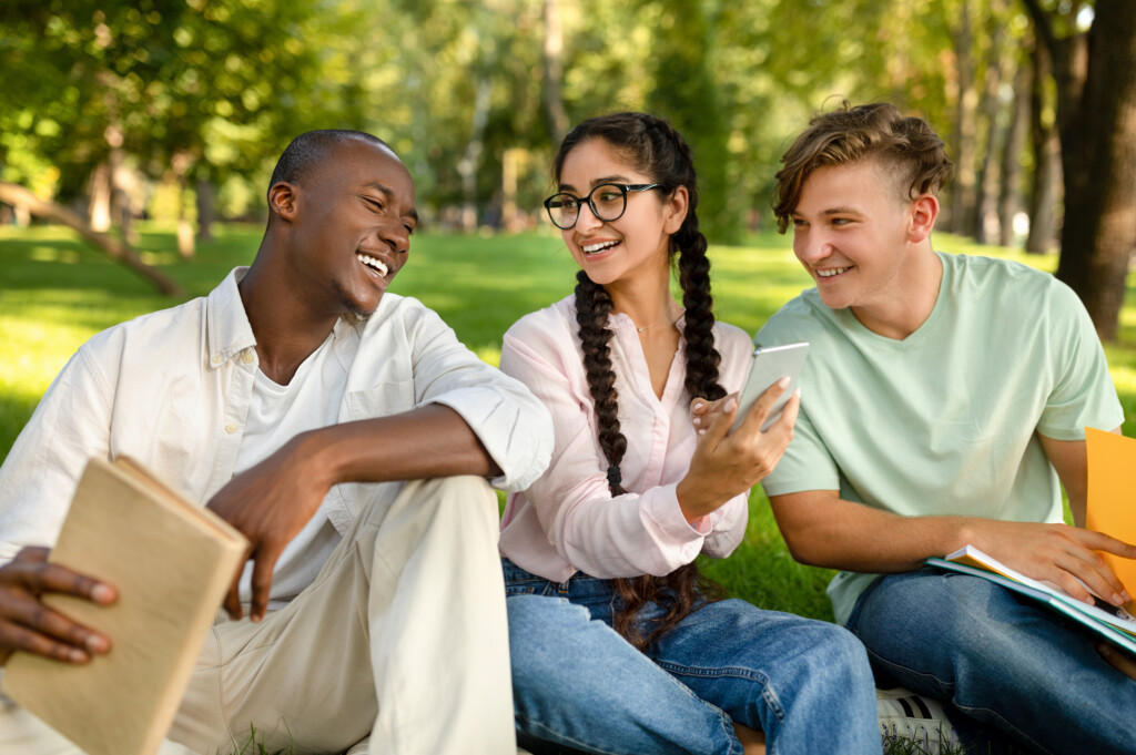 young people, a woman holding a cell phone