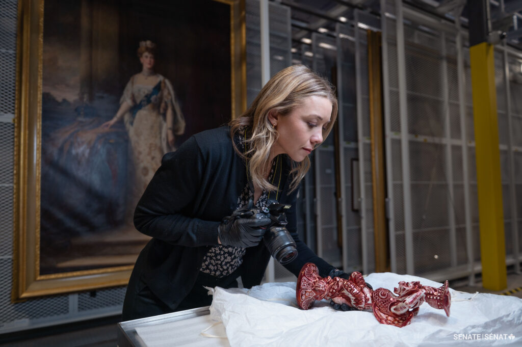 Meghan Paterson studies an artefact.