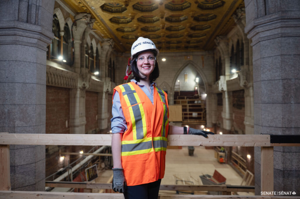 Natalie Whidden standing high above the Senate Chamber in Centre Block.
