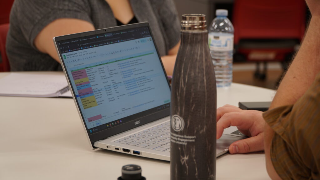 A participant's laptop is open as they catalogue short films from the Wapikoni archive.