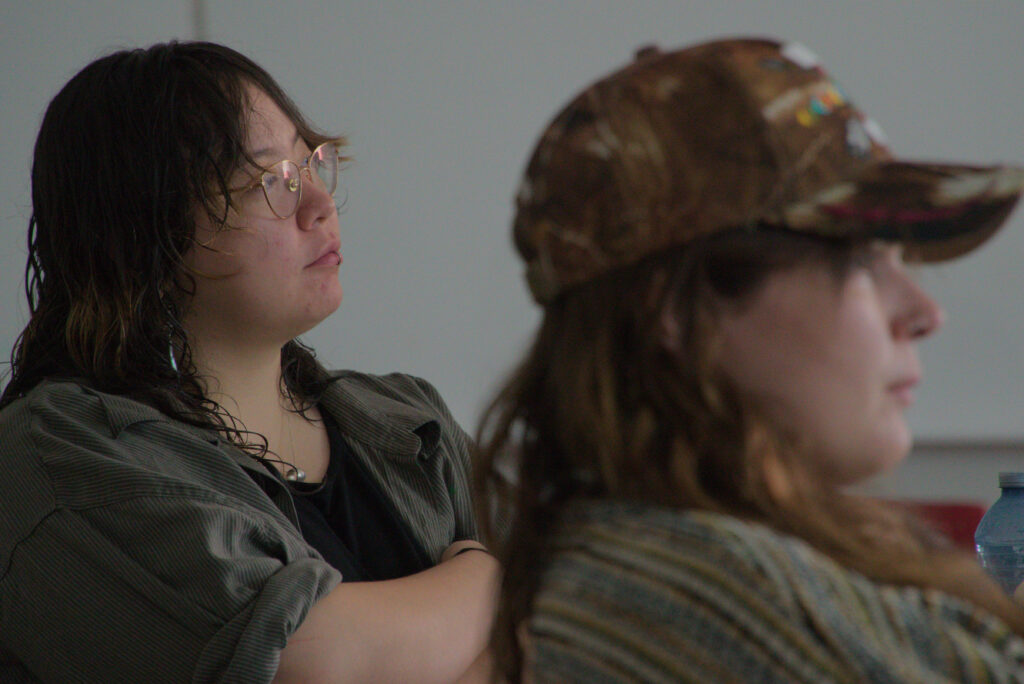 Two participant's sitting and listening attentivley during a workshop.