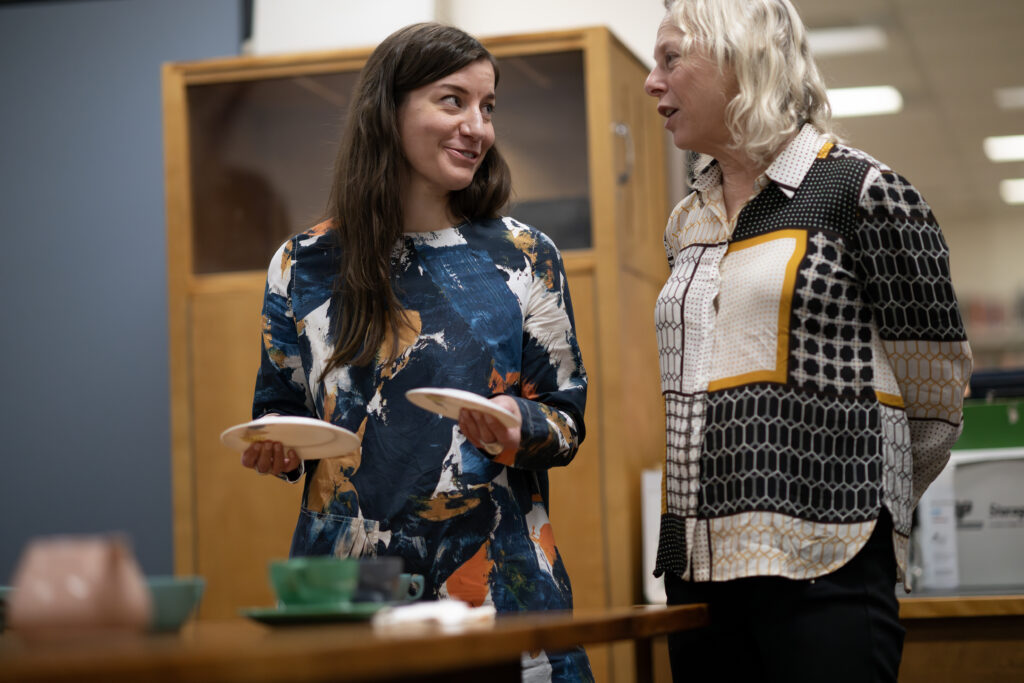 Romy Poletti and Rachel Gotlieb discuss Tecoware saucer and plate.
