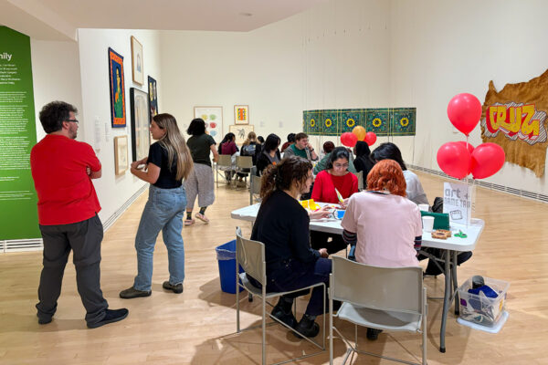 Groups of students sitting at tables making arts and crafts at the Carleton University Art Gallery.