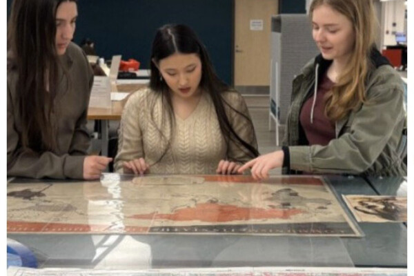 On the far left, first-year students, Arabella Skliar (left), Carys Murray (middle), and Maria Coates (right) evaluate a 1950 communist map, which they subsequently compare to a propaganda map from the late 1800s. Photographs by Emme Reynolds and Sherri Sunstrum.