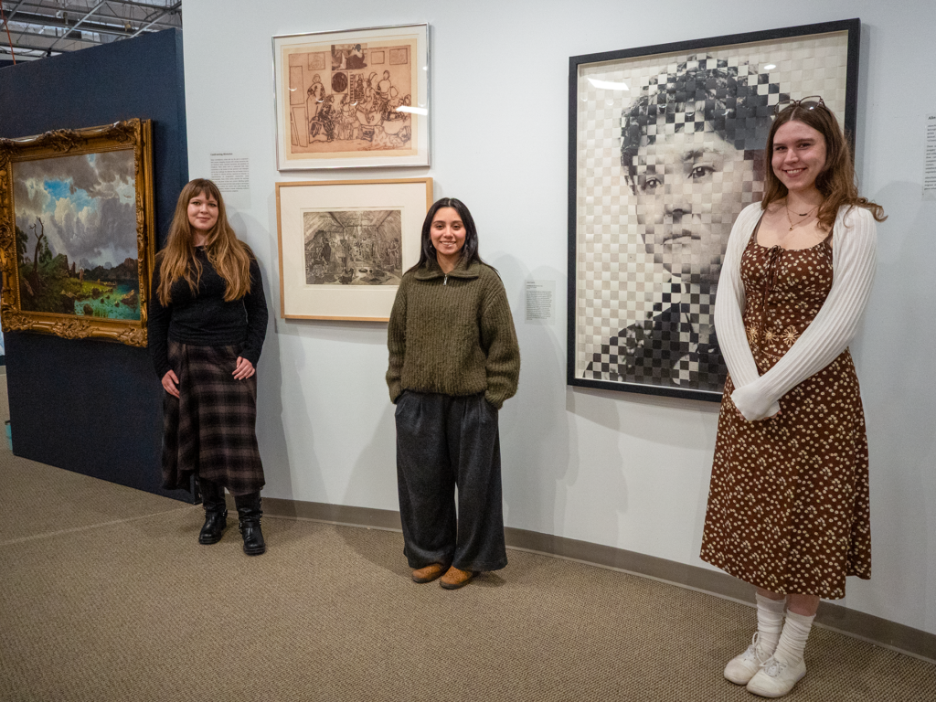 Students standing in front of their curated section of the exhibition.
