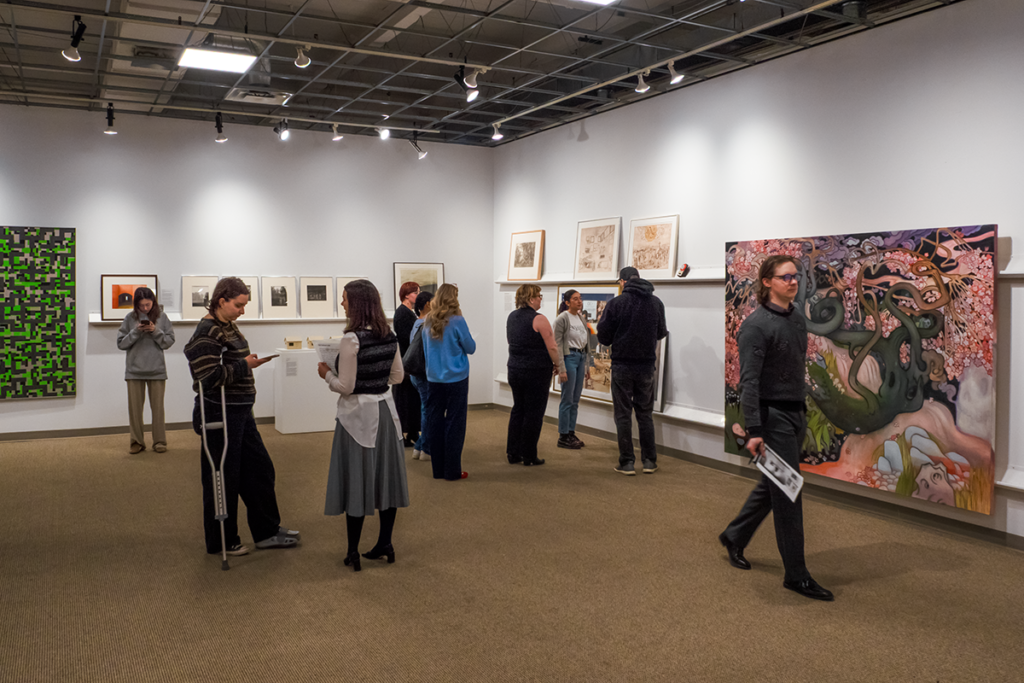 People walking around an art exhibition space
