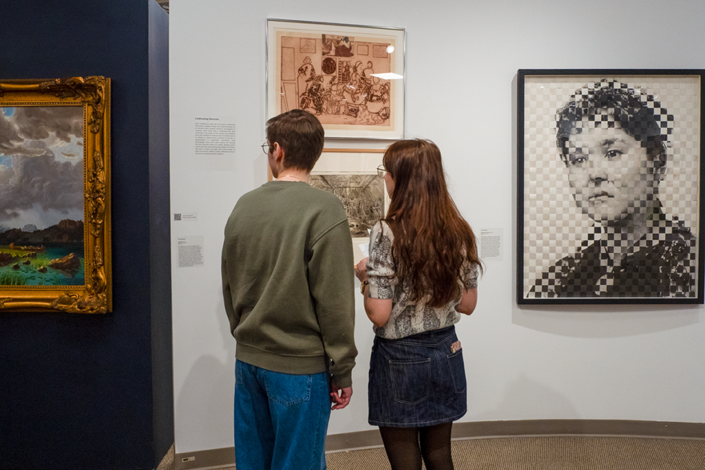 Two students taking in the exhibition.