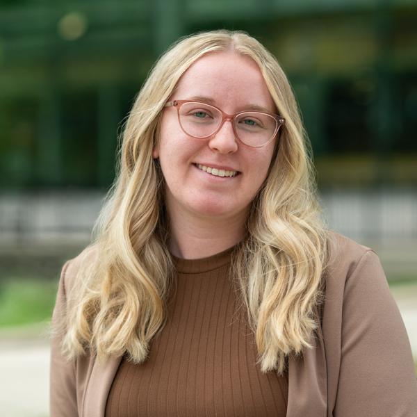 Student Ambassador with light hair, classes, and brown top