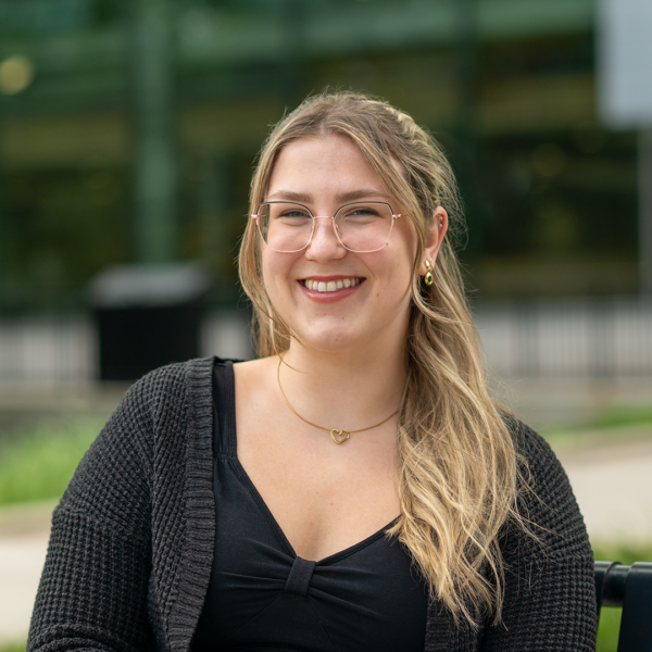 Student Ambassador wearing glasses with light hair and black shirt