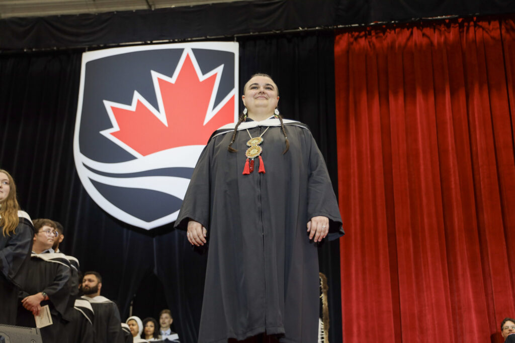 A graduate crossing the stage at Convocation.
