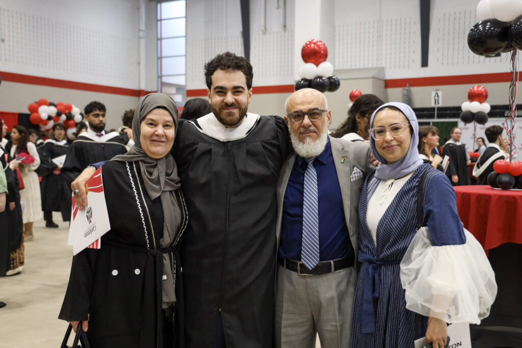 A graduate and their loved ones pose for a photo at Convocation.