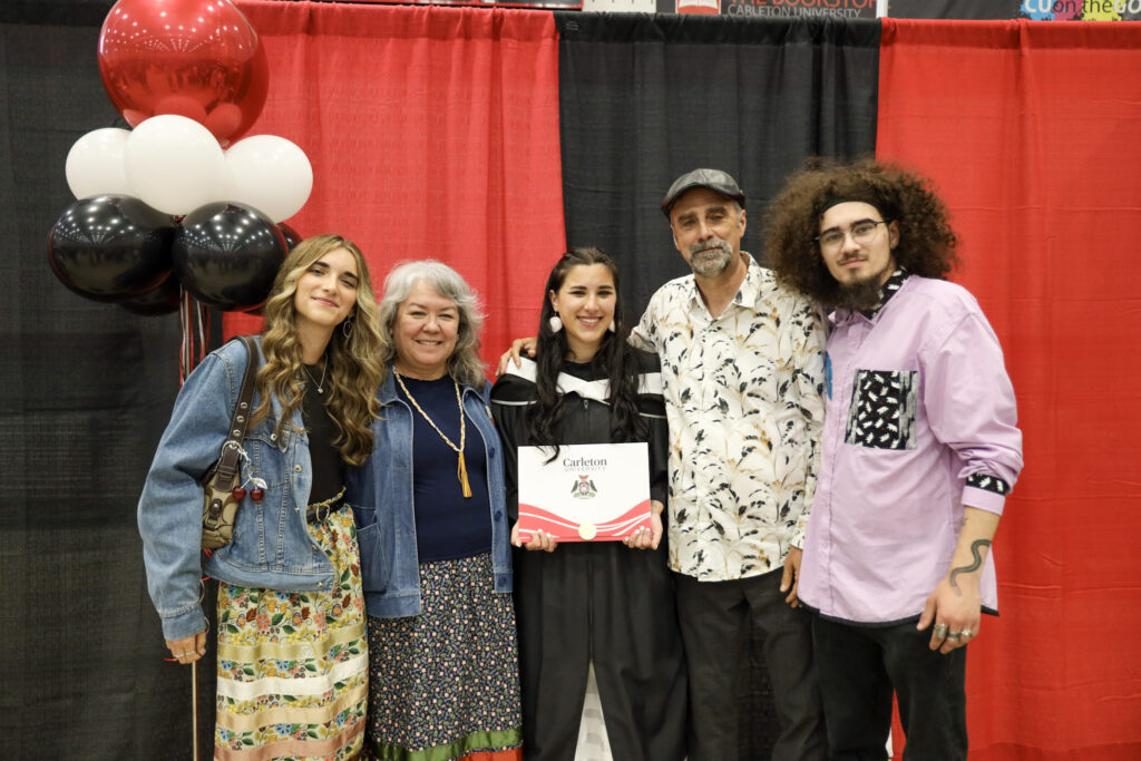 A graduate and their loved ones posing for a photo at Convocation.