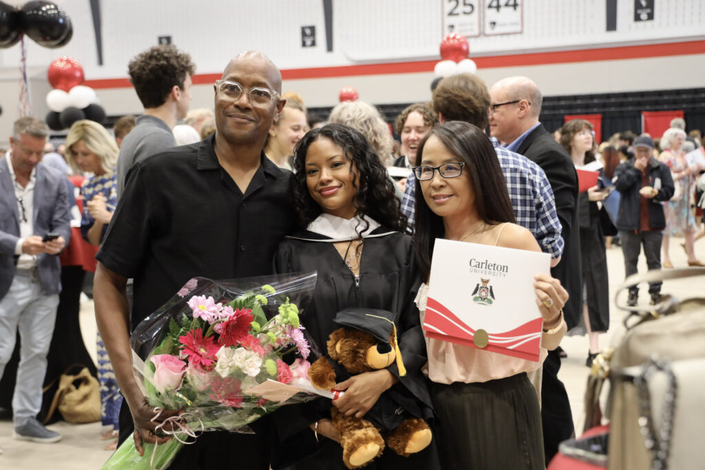 A graduate and their loved ones posing for a photo at Convocation.