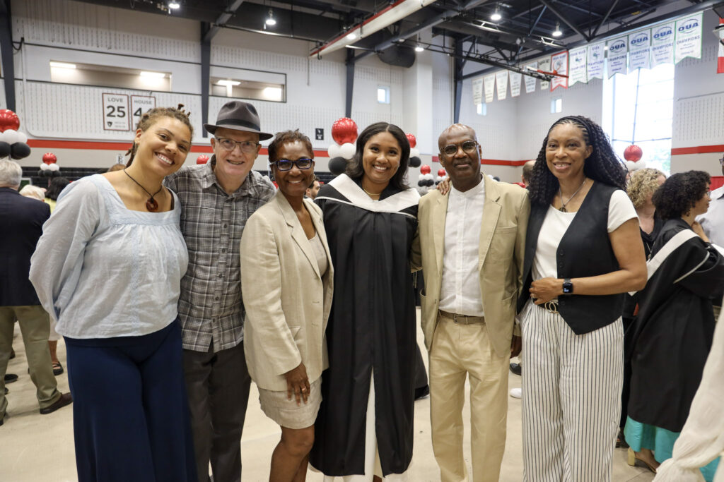 A graduate and their loved ones posing for a photo at Convocation.