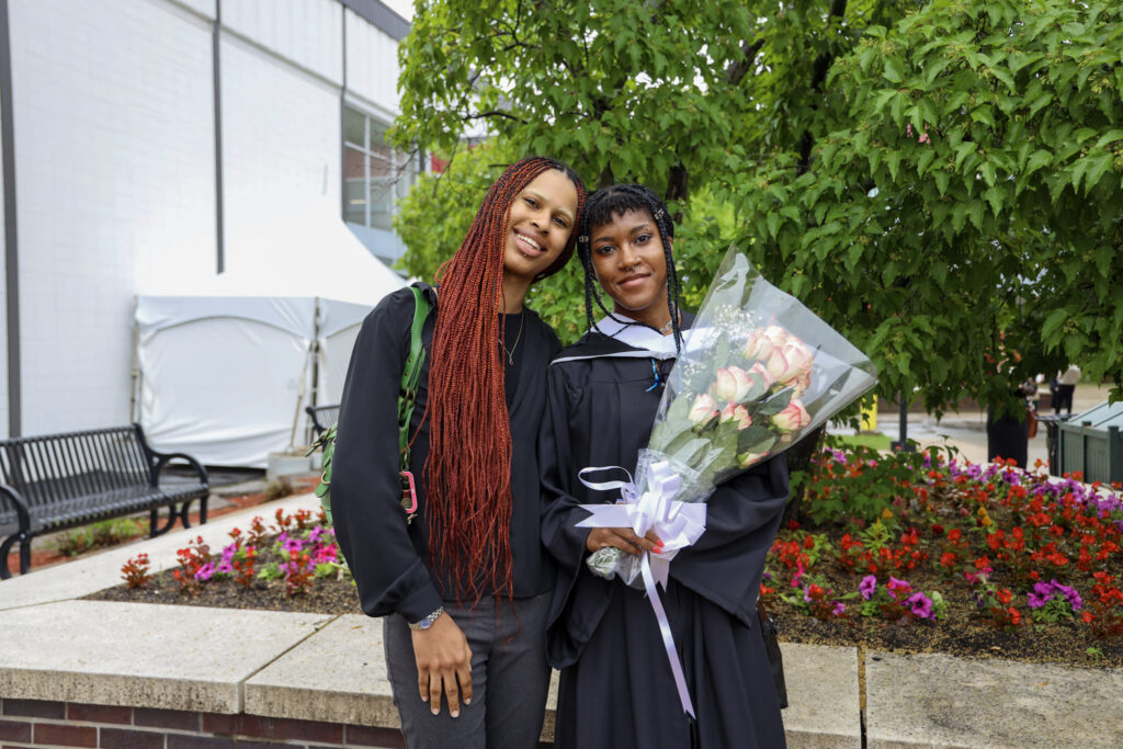 A graduate posing with a loved one for a photo at Convocation.