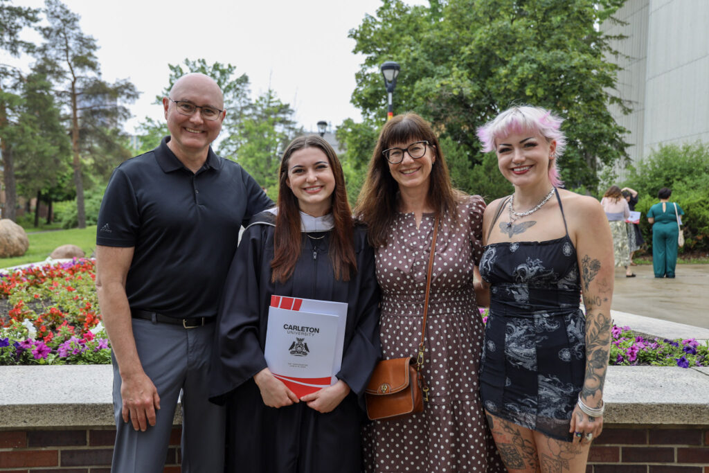A graduate and their loved ones posing for a photo at Convocation.