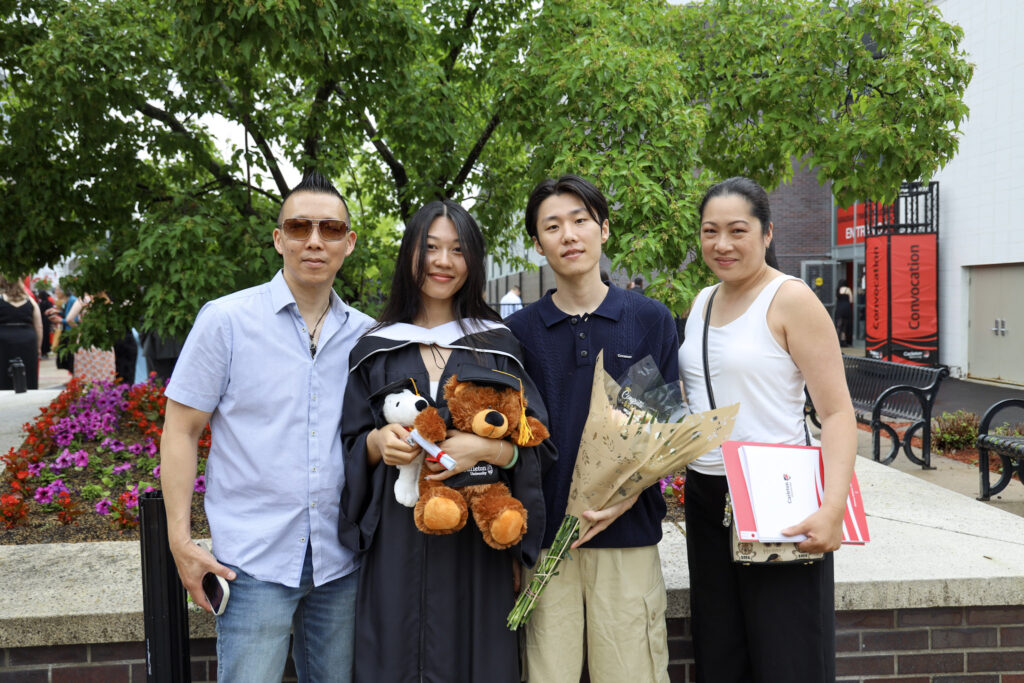 A graduate and their loved ones posing for a photo at Convocation.
