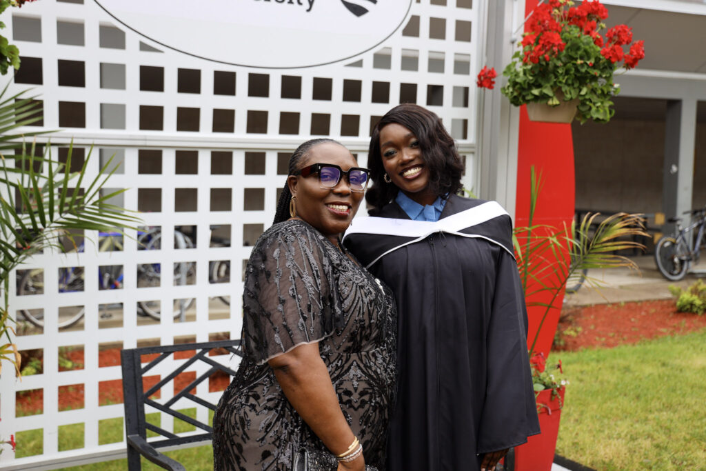 A graduate and their loved one posing for a photo at Convocation.