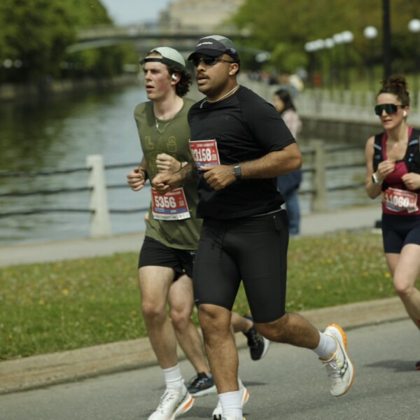 Student wearing all black running in marathon