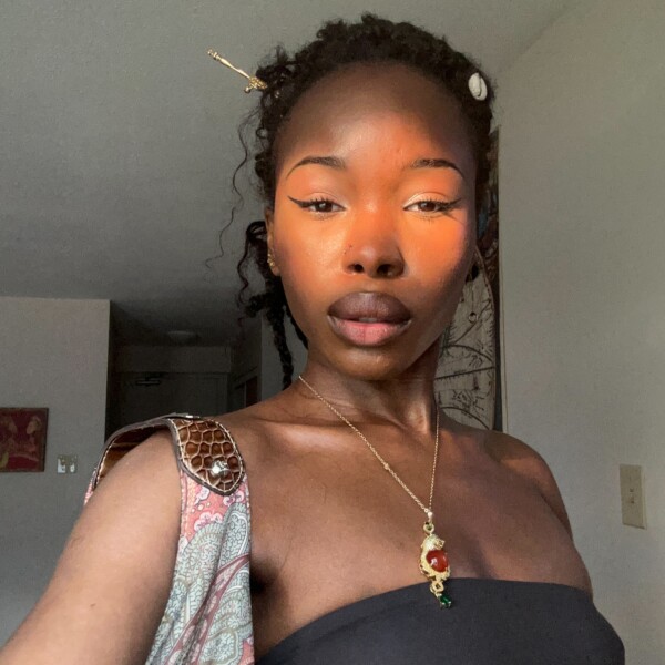 Student in black top with gold jewelry