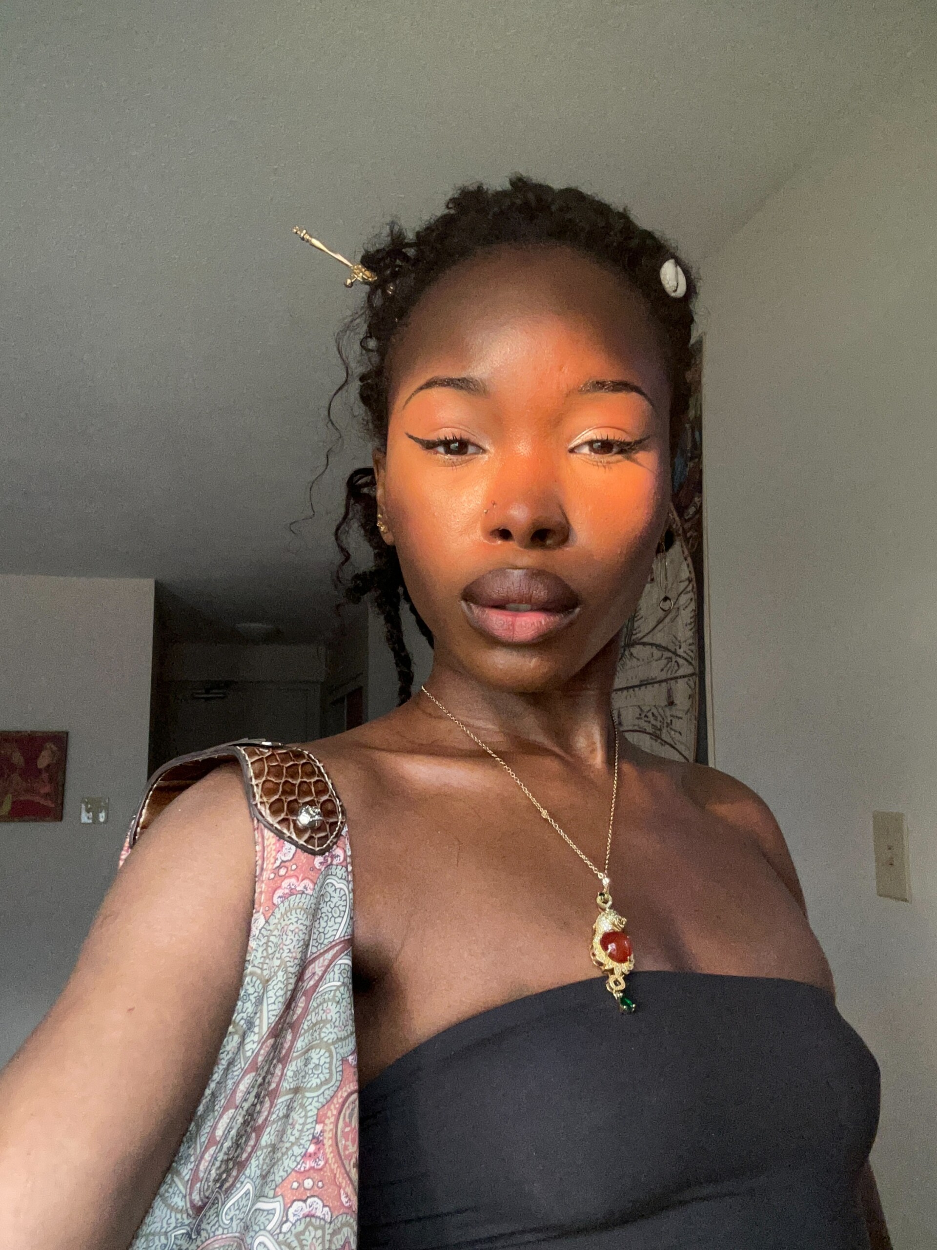 Student in black top with gold jewelry
