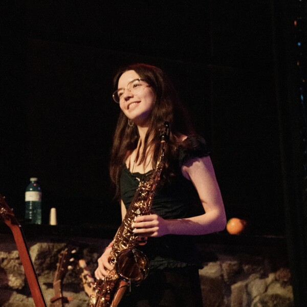 Student on stage with saxophone