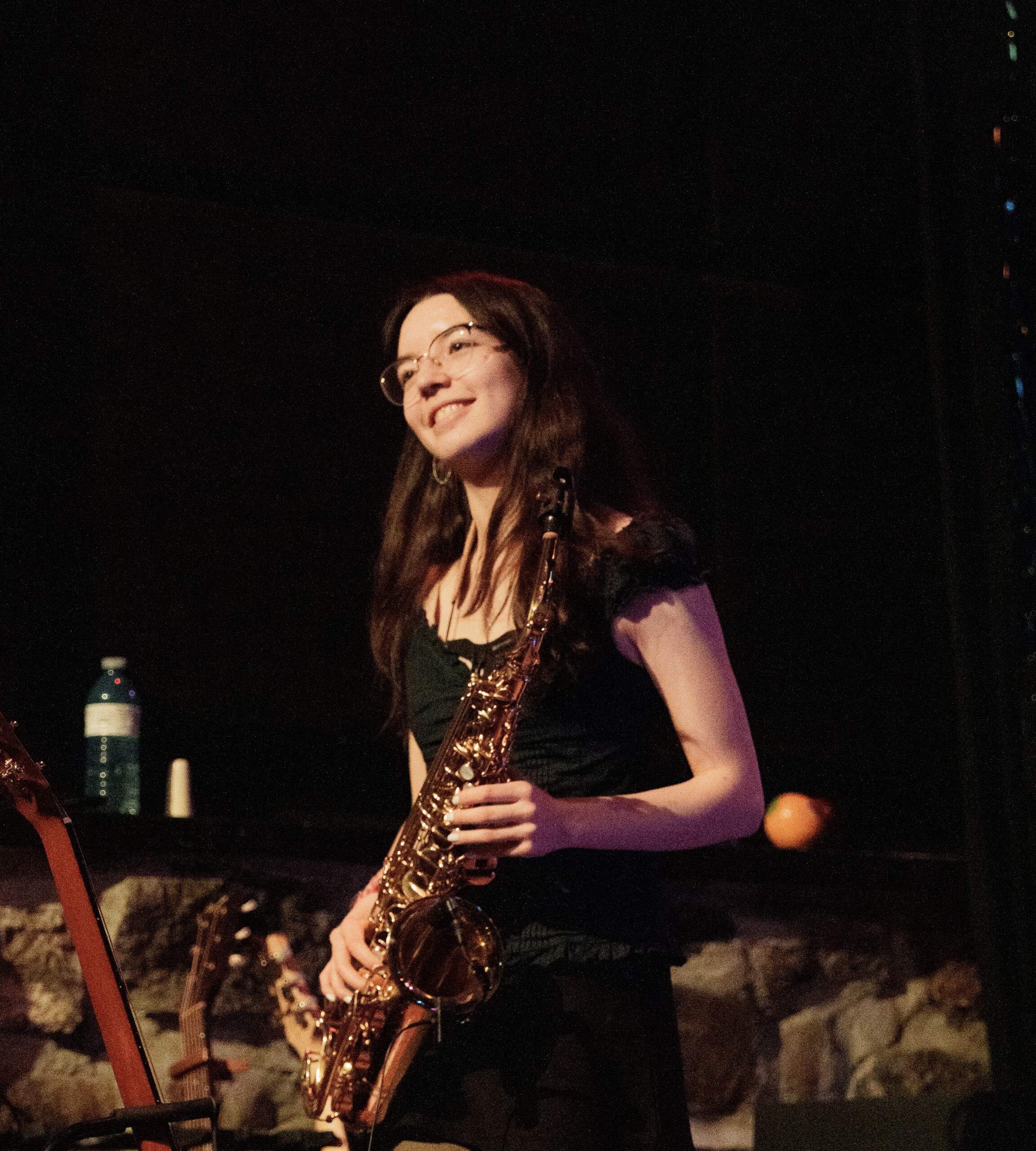 Student on stage with saxophone