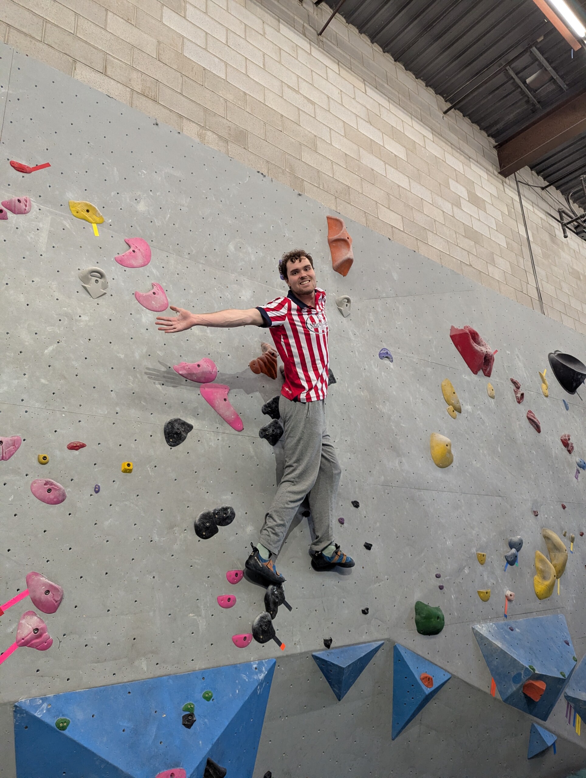 student ambassador on rock climbing wall