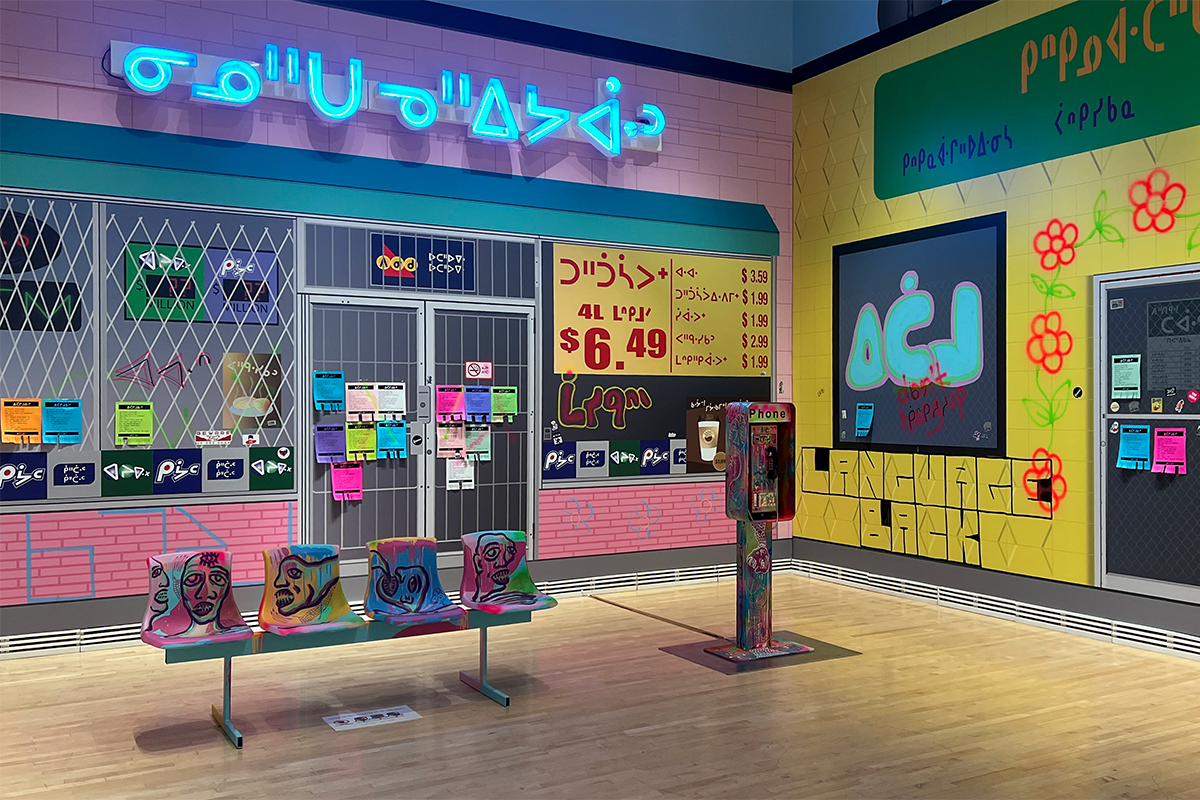 Colourful storefronts, seating and a phone booth featuring Cree writing.