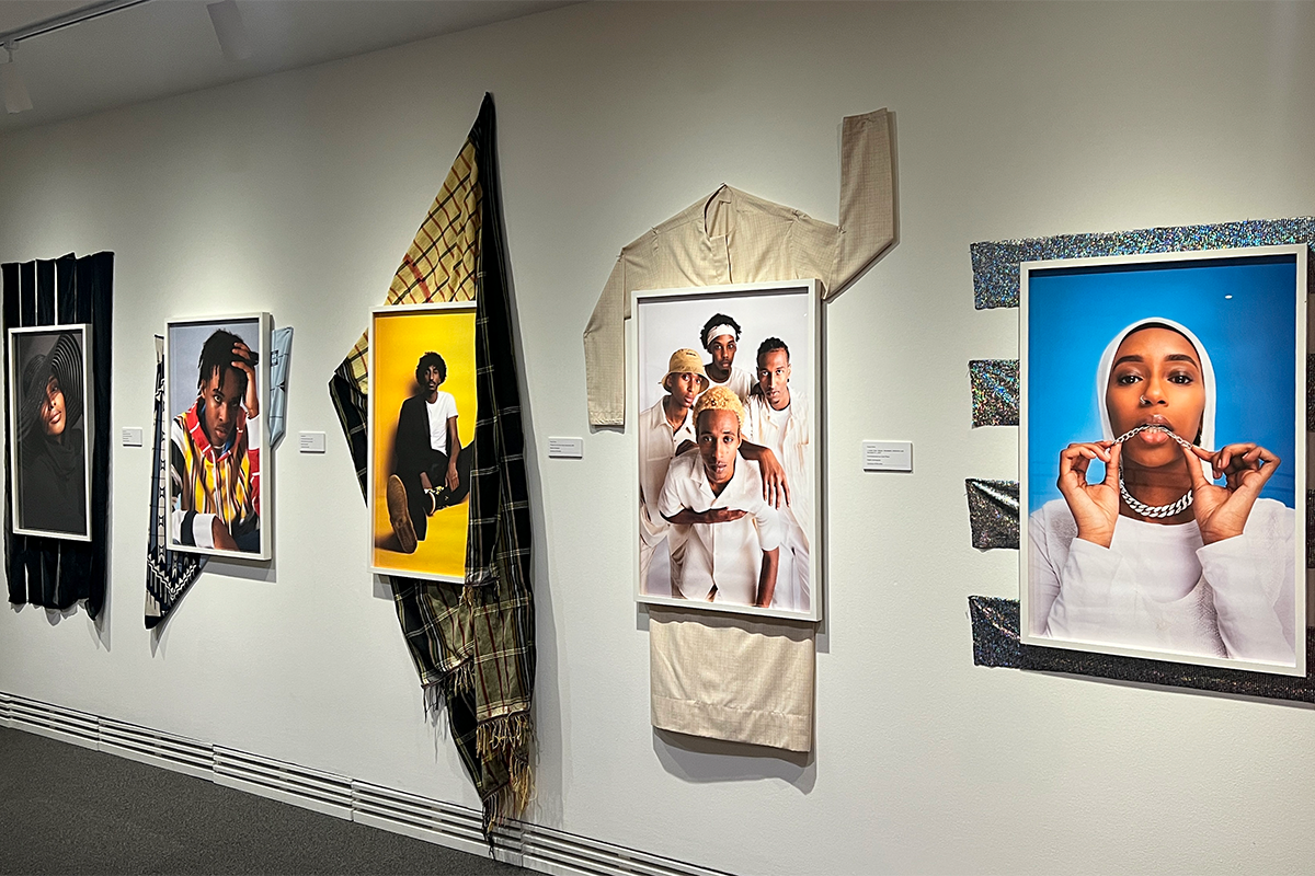 A series of framed portrait photos of Somali-Canadian community members.