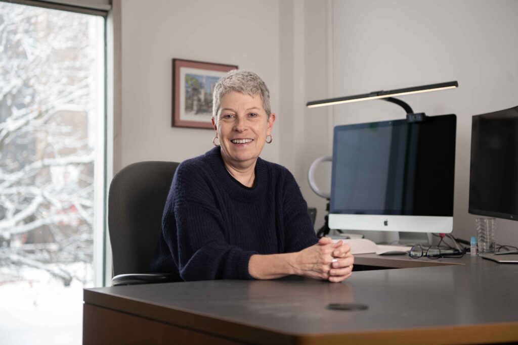 Dr. Anne Bowker in her office, she sits by her desk and her computer