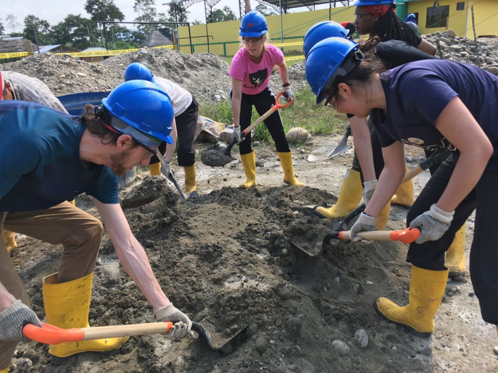 working together to dig a larger hole for a foundation