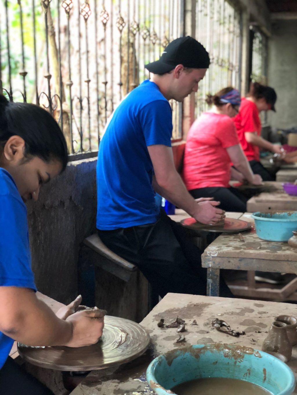 students working on pottery