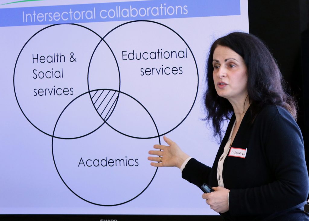 Claudia Rocca presenting her research titled, “If it does take a village to raise a child, how should the village do it?”