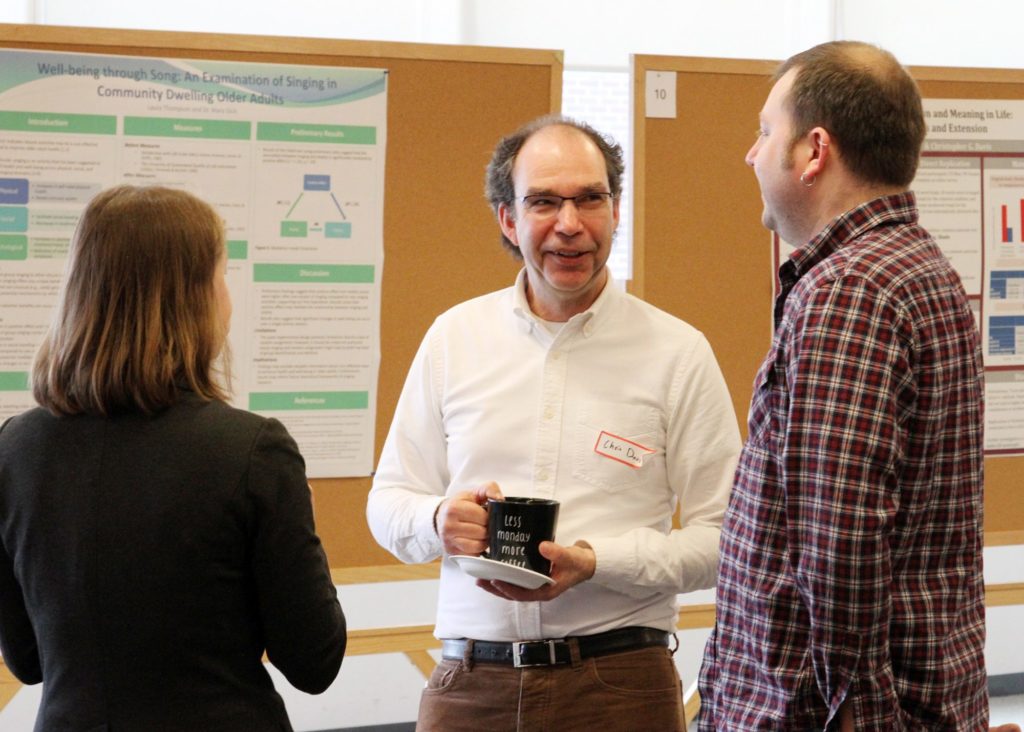 Dr. Marina Milyavskaya (left), Dr. Chris Davis (middle), and Dr. John Zelenski (right) at the poster session.