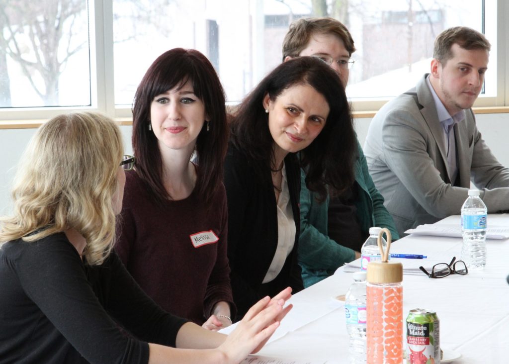 Psychology graduate students seated at the speaker panel before presenting their research.