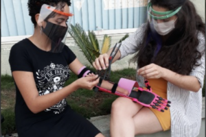 a medical professional fitting an arm prosthesis on a patient