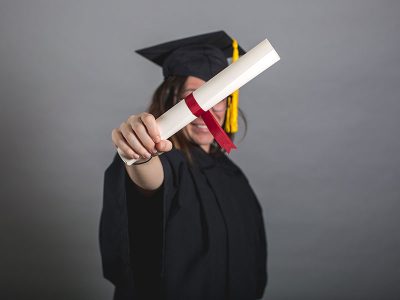 female-grad-student-holding-out-diploma-