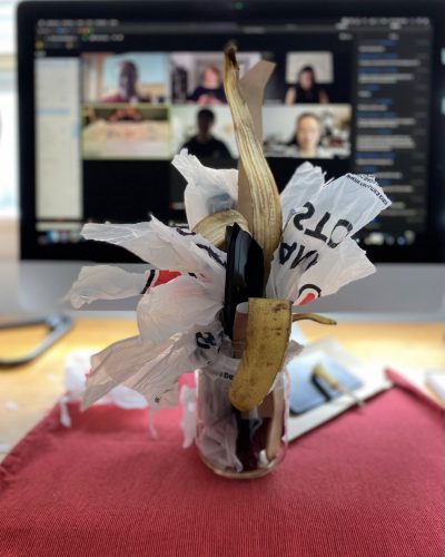 An art piece made from an old glass jar, scrap paper, and a banana peel.