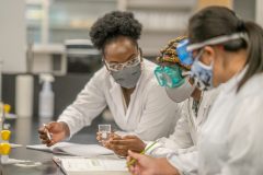 Graduate Students work in a lab. They are two women, one black and one white.