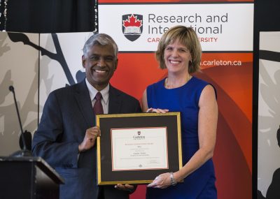 Professor Sarah Todd receiving her award from Nimal Rajapakse, Vice-President for Research and International