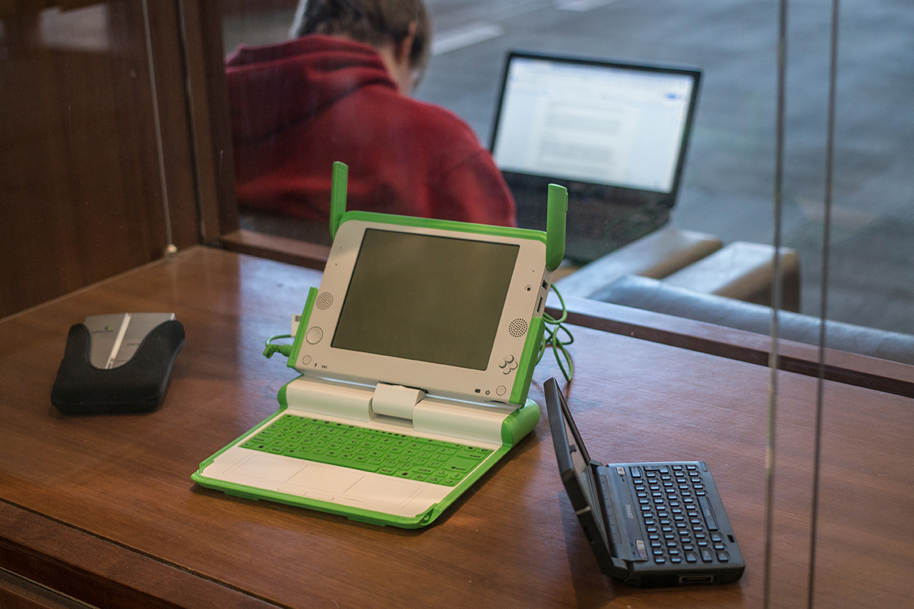 early laptop computers sit in the display case