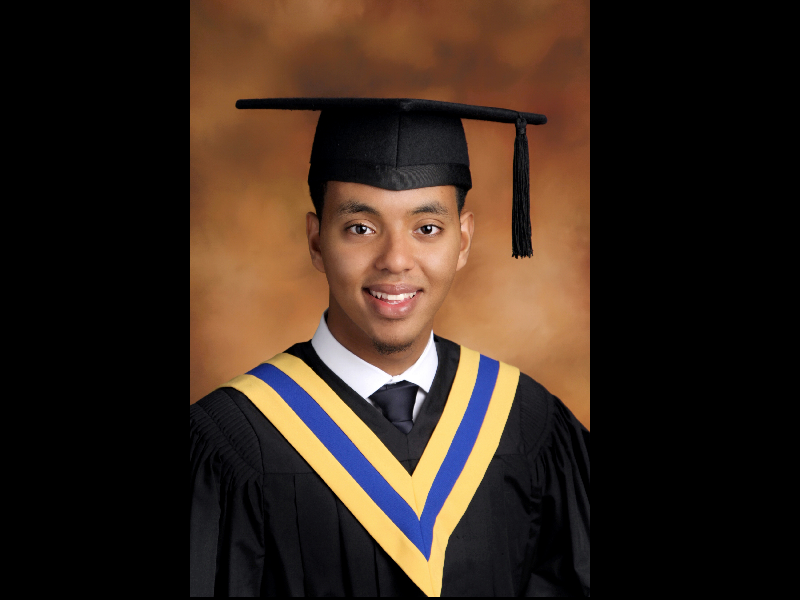 Headshot of Abel Mengistab in a cap and gown