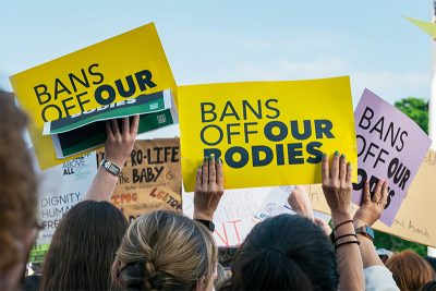 Protest signs saying "Bans off Our Bodies"