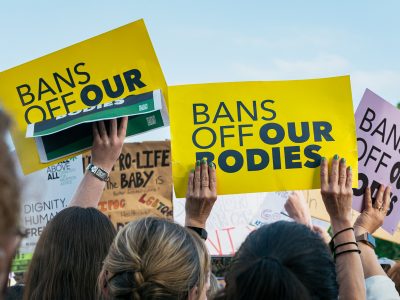 Protest signs saying "Bans off Our Bodies"